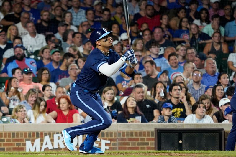 Jul 14, 2023; Chicago, Illinois, USA; Chicago Cubs second baseman Christopher Morel (5) hits an infield single against the Boston Red Sox during the sixth inning at Wrigley Field. Mandatory Credit: David Banks-USA TODAY Sports