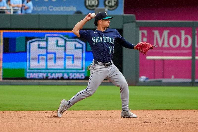 Sep 18, 2025; Kansas City, Missouri, USA; Seattle Mariners second baseman Leo Rivas (76) fields a ground ball against the Kansas City Royals and throws to first for an out during the seventh inning at Kauffman Stadium. Mandatory Credit: Denny Medley-Imagn Images