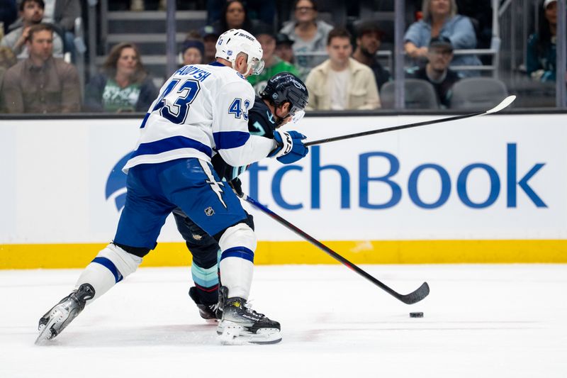 Mar 17, 2026; Seattle, Washington, USA; Tampa Bay Lightning defenseman Darren Raddysh (43) battles Seattle Kraken forward Jordan Eberle (7) for the puck during the second period at Climate Pledge Arena. Mandatory Credit: Stephen Brashear-Imagn Images