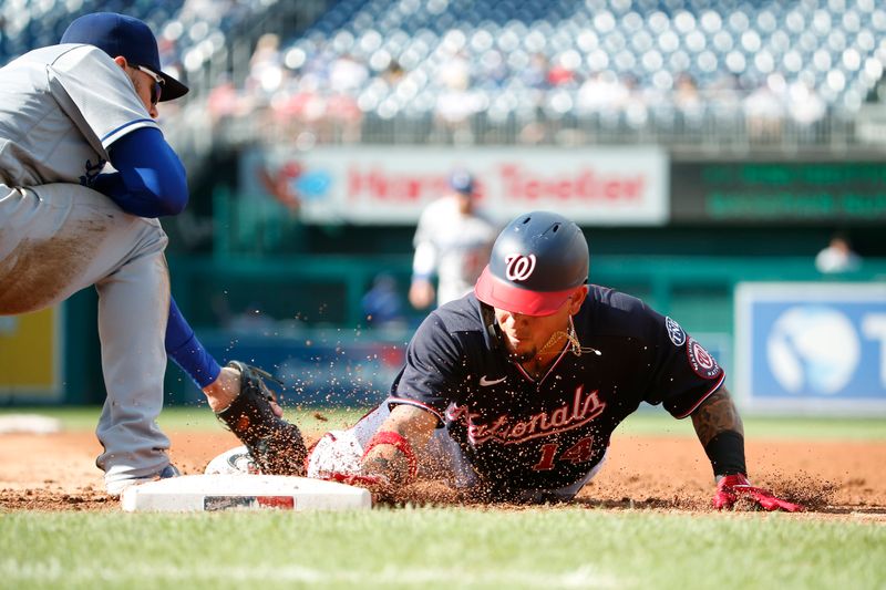 Sep 10, 2023; Washington, District of Columbia, USA; Washington Nationals shortstop Ildemaro Vargas (14) slides back to first base ahead of a tag by Los Angeles Dodgers first baseman Freddie Freeman (5) at Nationals Park. Mandatory Credit: Amber Searls-USA TODAY Sports