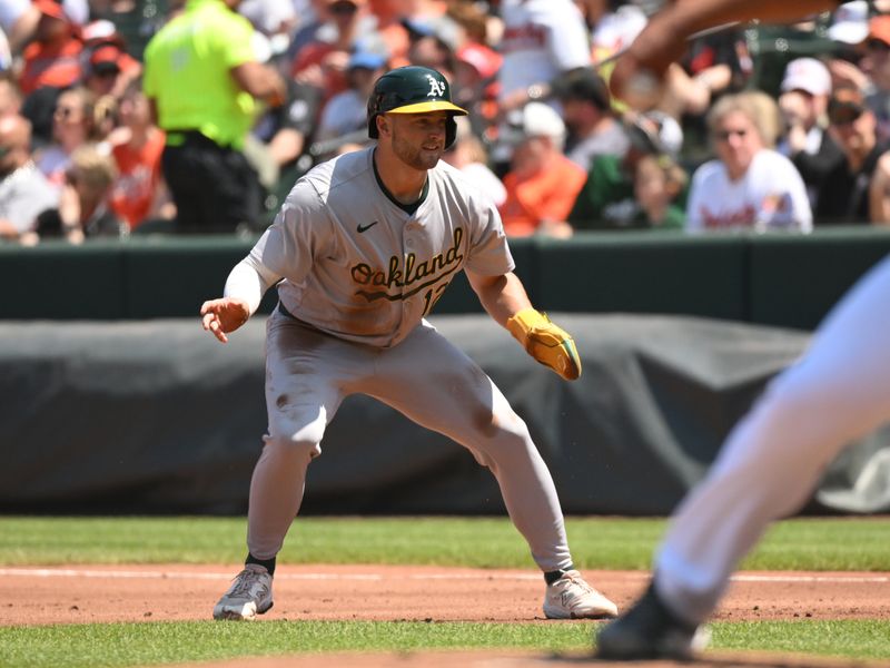 Apr 28, 2024; Baltimore, Maryland, USA;  Oakland Athletics third baseman Max Schuemann (12) takes a lead at first base during the second inning against the Baltimore Orioles at Oriole Park at Camden Yards. Mandatory Credit: James A. Pittman-USA TODAY Sports