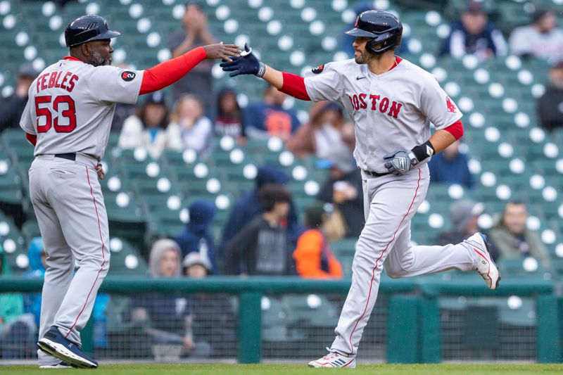 Apr 11, 2022; Detroit, Michigan, USA; Boston Red Sox designated hitter J.D. Martinez (28) celebrates with third base coach Carlos Febles (53) as he rounds the bases after hitting a solo home run during the fifth inning against the Detroit Tigers at Comerica Park. Mandatory Credit: Raj Mehta-USA TODAY Sports