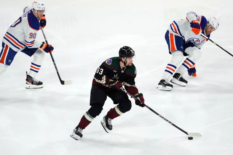 Feb 19, 2024; Tempe, Arizona, USA; Arizona Coyotes left wing Matias Maccelli (63) skates by Edmonton Oilers right wing Corey Perry (90) and Edmonton Oilers center Leon Draisaitl (29) during the first period at Mullett Arena. Mandatory Credit: Joe Camporeale-USA TODAY Sports