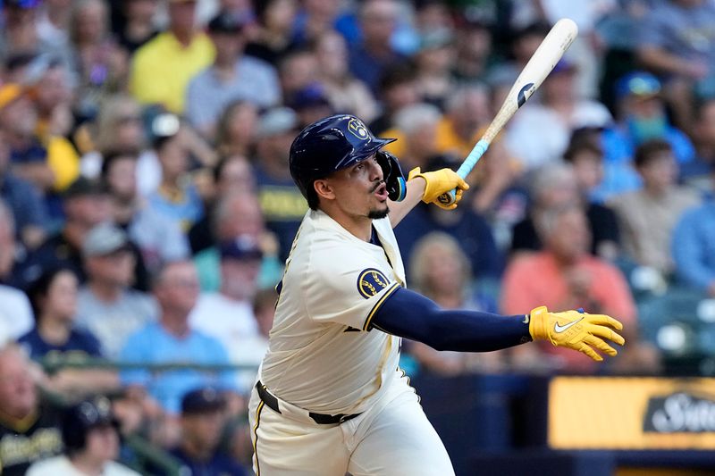 Jul 10, 2024; Milwaukee, Wisconsin, USA;  Milwaukee Brewers shortstop Willy Adames (27) hits an RBI double during the first inning against the Pittsburgh Pirates at American Family Field. Mandatory Credit: Jeff Hanisch-USA TODAY Sports
