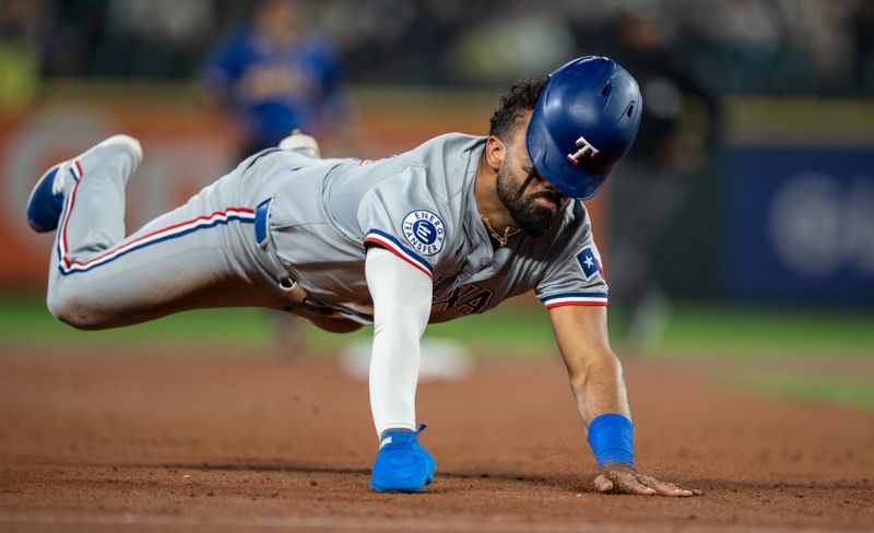 Sep 13, 2024; Seattle, Washington, USA;  Texas Rangers left fielder Ezequiel Duran (20) slides safely into third base during the second inning against the Seattle Mariners at T-Mobile Park. Mandatory Credit: Stephen Brashear-Imagn Images