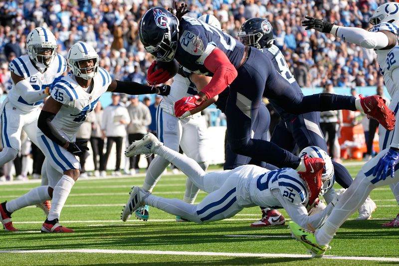 Tennessee Titans running back Derrick Henry (22) dives into the end zone for a touchdown past Indianapolis Colts safety Rodney Thomas II (25) during the first half of an NFL football game Sunday, Dec. 3, 2023, in Nashville, Tenn. (AP Photo/George Walker IV)