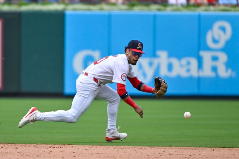 Jul 14, 2024; St. Louis, Missouri, USA;  St. Louis Cardinals shortstop Masyn Winn (0) dives and fields a ground ball against the Chicago Cubs during the ninth inning at Busch Stadium. Mandatory Credit: Jeff Curry-USA TODAY Sports