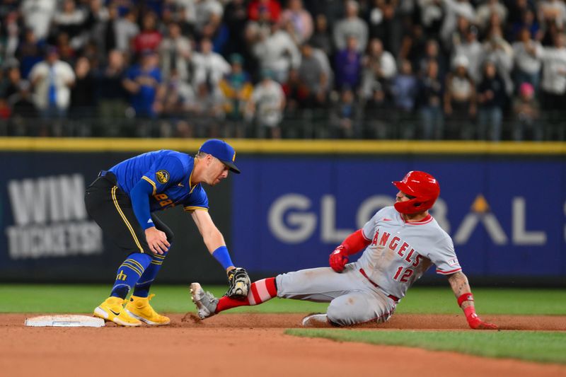 May 31, 2024; Seattle, Washington, USA; Seattle Mariners second baseman Dylan Moore (25) tags out Los Angeles Angels right fielder Kevin Pillar (12) at second base during a stolen base attempt for the final out of the game at T-Mobile Park. Mandatory Credit: Steven Bisig-USA TODAY Sports