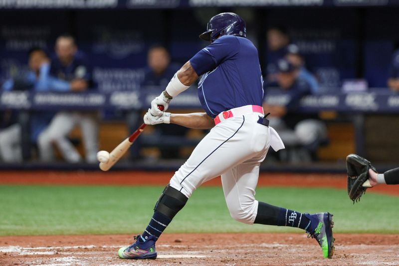 Sep 9, 2023; St. Petersburg, Florida, USA;  Tampa Bay Rays first baseman Yandy Diaz (2) hits an rbi double against the Seattle Mariners in the seventh inning at Tropicana Field. Mandatory Credit: Nathan Ray Seebeck-USA TODAY Sports