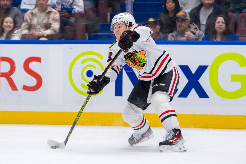 Nov 16, 2024; Vancouver, British Columbia, CAN; Chicago Blackhawks forward Connor Bedard (98) makes a pass against the Vancouver Canucks during the third period at Rogers Arena. Mandatory Credit: Bob Frid-Imagn Images