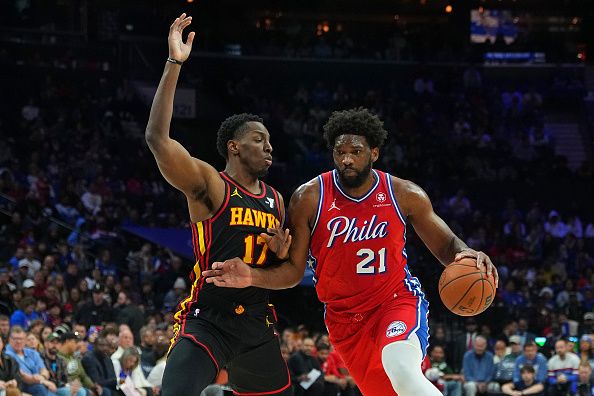 PHILADELPHIA, PENNSYLVANIA - DECEMBER 8: Joel Embiid #21 of the Philadelphia 76ers drives to the basket against Onyeka Okongwu #17 of the Atlanta Hawks in the first quarter at the Wells Fargo Center on December 8, 2023 in Philadelphia, Pennsylvania. NOTE TO USER: User expressly acknowledges and agrees that, by downloading and or using this photograph, User is consenting to the terms and conditions of the Getty Images License Agreement. (Photo by Mitchell Leff/Getty Images)