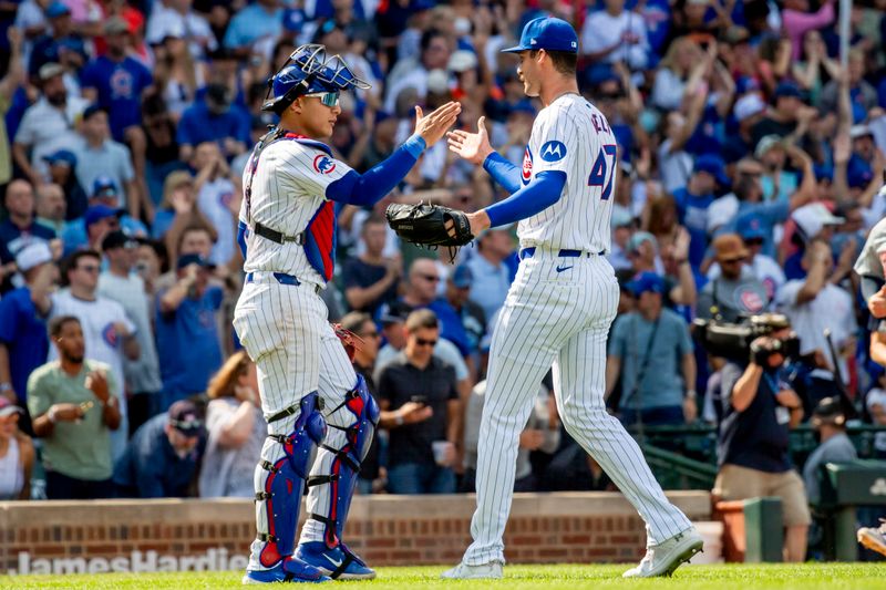 Aug 22, 2024; Chicago, Illinois, USA; Chicago Cubs catcher Miguel Amaya (left) and relief pitcher Jack Neely (right) celebrate after defeating the Detroit Tigers at Wrigley Field. Mandatory Credit: Patrick Gorski-USA TODAY Sports