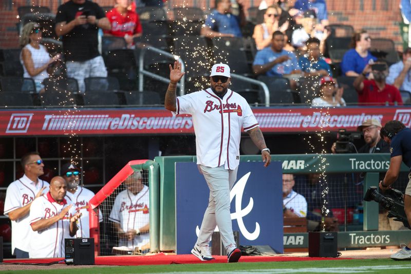 Jul 22, 2024; Atlanta, Georgia, USA; Former Atlanta Braves center fielder Andruw Jones is honored before a game against the Cincinnati Reds at Truist Park. Mandatory Credit: Brett Davis-USA TODAY Sports
