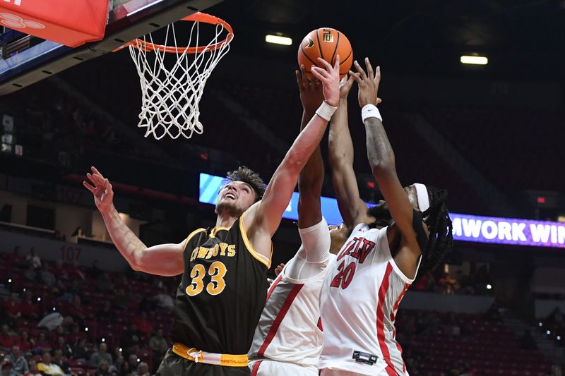 Feb 3, 2024; Las Vegas, Nevada, USA; Wyoming Cowboys forward Mason Walters (33) battles for a rebound with UNLV Rebels forward Keylan Boone (20) and forward Rob Whaley Jr. (5) in the second half at Thomas & Mack Center. Mandatory Credit: Candice Ward-USA TODAY Sports