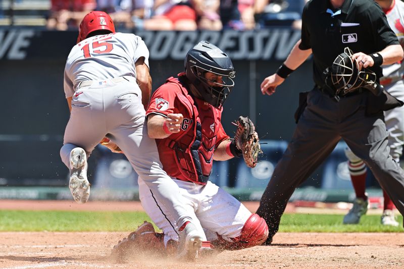 Jun 29, 2025; Cleveland, Ohio, USA; St. Louis Cardinals pinch hitter Jose Fermin (15) nearly collides with Cleveland Guardians catcher Austin Hedges (27) while scoring on a sacrifice fly during the eighth inning at Progressive Field. Mandatory Credit: Ken Blaze-Imagn Images