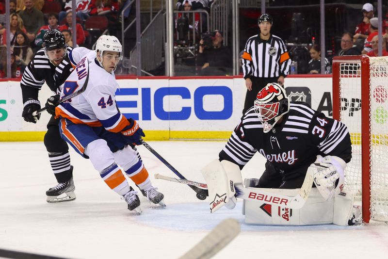 Apr 15, 2024; Newark, New Jersey, USA; New Jersey Devils goaltender Jake Allen (34) makes a save against the New York Islanders during the third period at Prudential Center. Mandatory Credit: Ed Mulholland-USA TODAY Sports