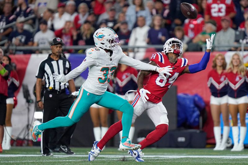 Miami Dolphins cornerback Eli Apple (33) pressures New England Patriots wide receiver Kendrick Bourne (84) on an incomplete pass during the first half of an NFL football game, Sunday, Sept. 17, 2023, in Foxborough, Mass. (AP Photo/Steven Senne)