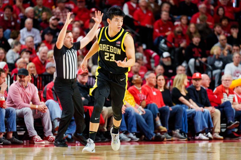 Jan 13, 2026; Lincoln, Nebraska, USA; Oregon Ducks guard Wei Lin (23) celebrates after a three point basket during the first half against the Oregon Ducks at Pinnacle Bank Arena. Mandatory Credit: Dylan Widger-Imagn Images
