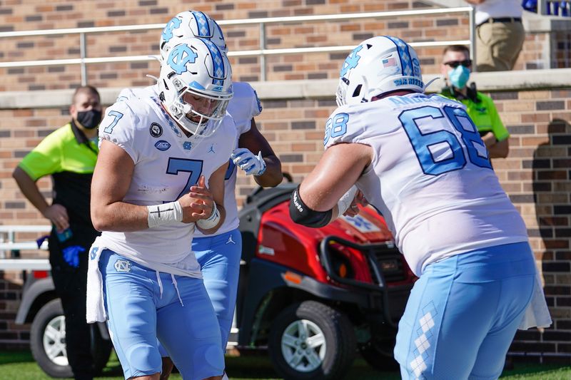 Nov 7, 2020; Durham, North Carolina, USA;  North Carolina Tar Heels quarterback Sam Howell (7) celebrates with lineman Brian Anderson (68) during the first quarter at Wallace Wade Stadium. Mandatory Credit: Jim Dedmon-USA TODAY Sports