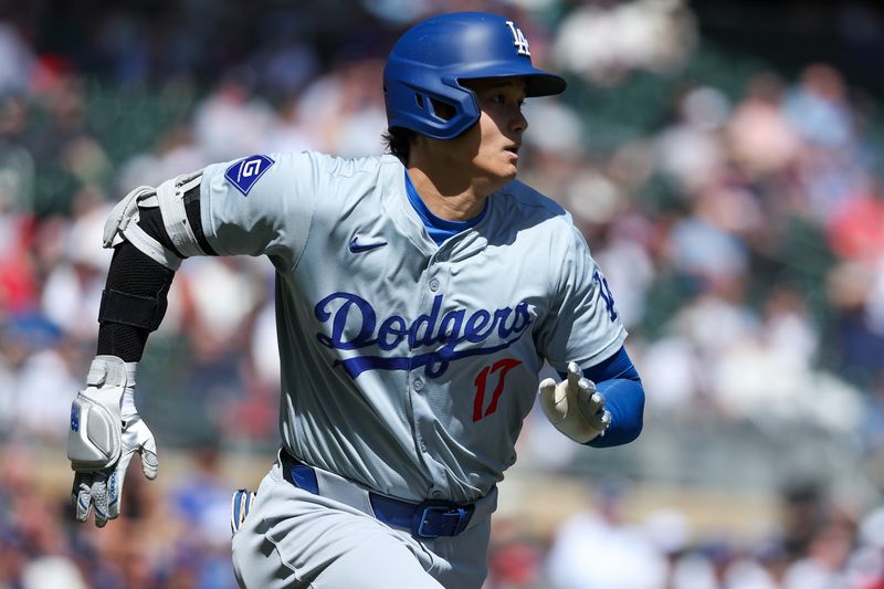 Apr 10, 2024; Minneapolis, Minnesota, USA; Los Angeles Dodgers designated hitter Shohei Ohtani (17) hits a single against the Minnesota Twins during the fourth inning at Target Field. Mandatory Credit: Matt Krohn-USA TODAY Sports