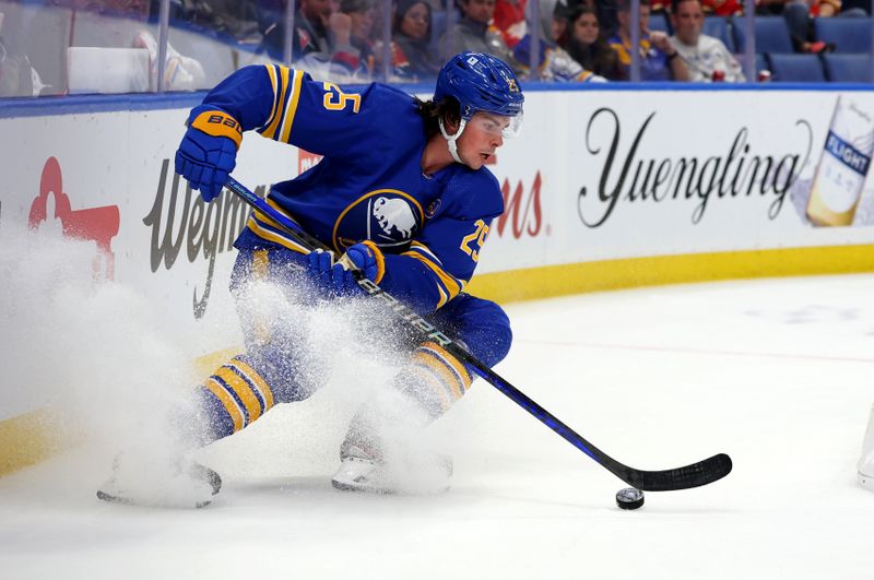 Oct 19, 2023; Buffalo, New York, USA;  Buffalo Sabres defenseman Owen Power (25) looks to control the puck during the third period against the Calgary Flames at KeyBank Center. Mandatory Credit: Timothy T. Ludwig-USA TODAY Sports