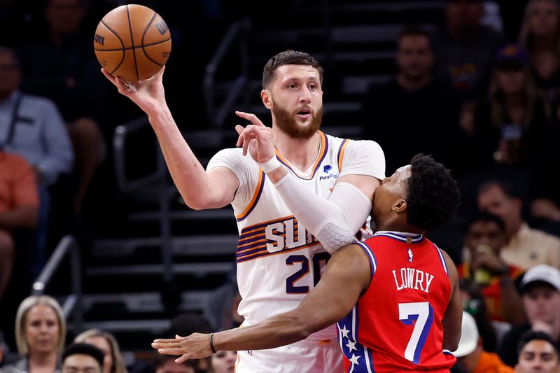 PHOENIX, ARIZONA - MARCH 20: Jusuf Nurkic #20 of the Phoenix Suns passes over Kyle Lowry #7 of the Philadelphia 76ers during the first half at Footprint Center on March 20, 2024 in Phoenix, Arizona. NOTE TO USER: User expressly acknowledges and agrees that, by downloading and or using this photograph, User is consenting to the terms and conditions of the Getty Images License Agreement.  (Photo by Chris Coduto/Getty Images)