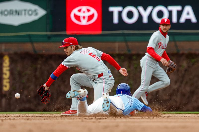 Apr 25, 2025; Chicago, Illinois, USA; Chicago Cubs center fielder Pete Crow-Armstrong (4) steals second base against Philadelphia Phillies second baseman Bryson Stott (5) during the second inning at Wrigley Field. Mandatory Credit: Kamil Krzaczynski-Imagn Images