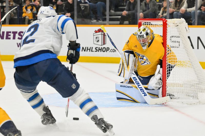 Nov 29, 2025; Nashville, Tennessee, USA; Winnipeg Jets right wing Nino Niederreiter (62) shoots the puck against Nashville Predators goaltender Justus Annunen (29) during the second period at Bridgestone Arena. Mandatory Credit: Steve Roberts-Imagn Images