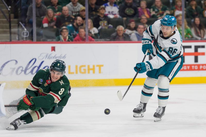 Nov 11, 2025; Saint Paul, Minnesota, USA; San Jose Sharks center Philipp Kurashev (96) shoots as Minnesota Wild defenseman Zeev Buium (8) tries to block the shot in the third period at Grand Casino Arena. Mandatory Credit: Matt Blewett-Imagn Images