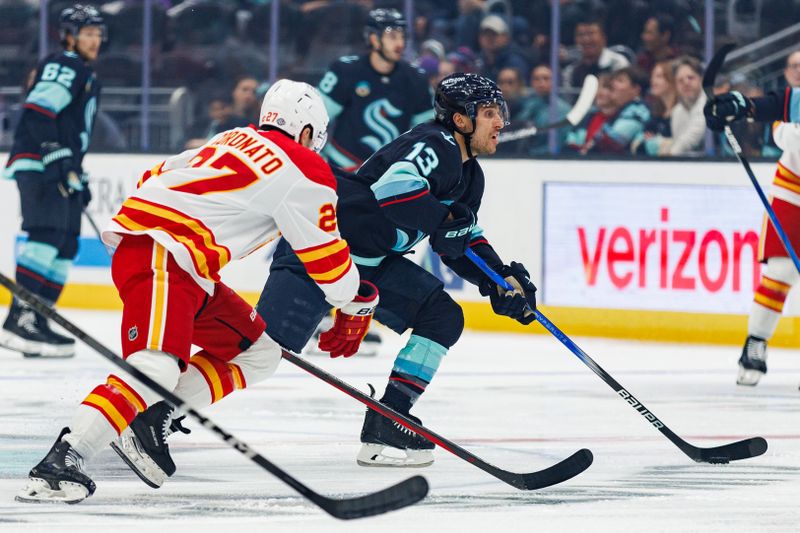 Oct 19, 2024; Seattle, Washington, USA; Seattle Kraken left wing Brandon Tanev (13) skates against Calgary Flames right wing Matt Coronato (27) during the first period at Climate Pledge Arena. Mandatory Credit: Caean Couto-Imagn Images