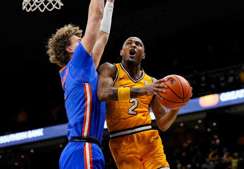 Jan 20, 2024; Columbia, Missouri, USA; Missouri Tigers guard Tamar Bates (2) goes up for a shot against Florida Gators center Micah Handlogten (3) during the first half at Mizzou Arena. Mandatory Credit: Jay Biggerstaff-USA TODAY Sports