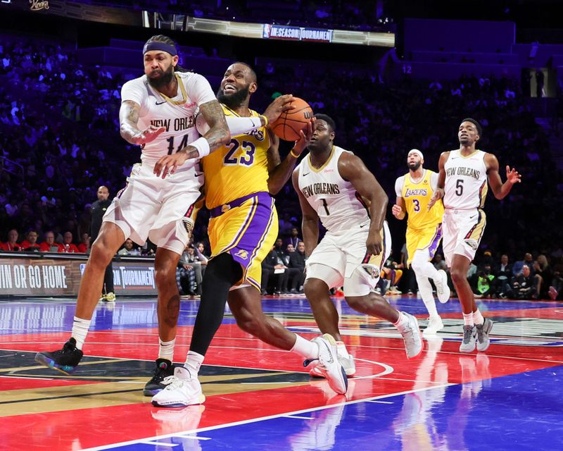 LAS VEGAS, NEVADA - DECEMBER 07: LeBron James #23 of the Los Angeles Lakers is fouled as he drives against Brandon Ingram #14 of the New Orleans Pelicans in the first half of the West semifinal game of the inaugural NBA In-Season Tournament at T-Mobile Arena on December 07, 2023 in Las Vegas, Nevada. The Lakers defeated the Pelicans 133-89. NOTE TO USER: User expressly acknowledges and agrees that, by downloading and or using this photograph, User is consenting to the terms and conditions of the Getty Images License Agreement.  (Photo by Ethan Miller/Getty Images)