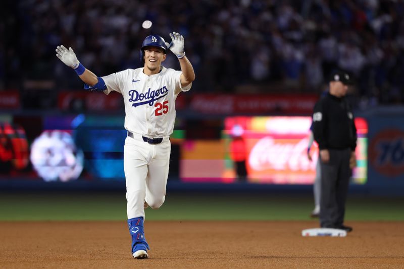 Sep 11, 2024; Los Angeles, California, USA;  Los Angeles Dodgers center fielder Tommy Edman (25) reacts while running around bases on a 2-run home run during the eighth inning against the Chicago Cubs at Dodger Stadium. Mandatory Credit: Kiyoshi Mio-Imagn Images