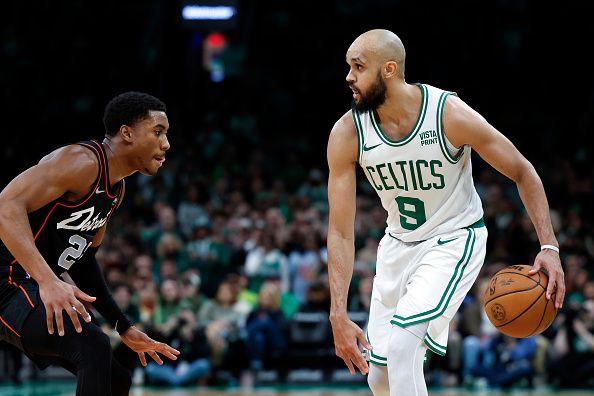 Boston, MA - December 28: Boston Celtics PG Derrick White sizes up Detroit Pistons SG Jaden Ivey in the second half. The Celtics beat the Detroit Pistons, 128-122, in overtime. (Photo by Danielle Parhizkaran/The Boston Globe via Getty Images)