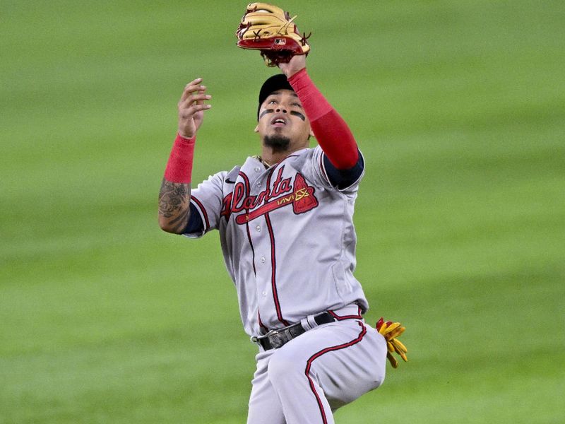 May 16, 2023; Arlington, Texas, USA; Atlanta Braves shortstop Orlando Arcia (11) fields a ball hit by Texas Rangers first baseman Nathaniel Lowe (not pictured) during the first inning at Globe Life Field. Mandatory Credit: Jerome Miron-USA TODAY Sports