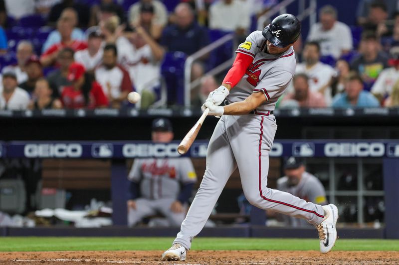 Sep 16, 2023; Miami, Florida, USA; Atlanta Braves first baseman Matt Olson (28) hits a home run against the Miami Marlins during the sixth inning at loanDepot Park. Mandatory Credit: Sam Navarro-USA TODAY Sports