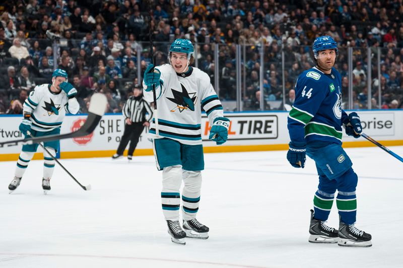 Dec 27, 2025; Vancouver, British Columbia, CAN; Vancouver Canucks forward Kiefer Sherwood (44) reacts as San Jose Sharks forward Macklin Celebrini (71) celebrates his goal in the third period at Rogers Arena. Mandatory Credit: Bob Frid-Imagn Images