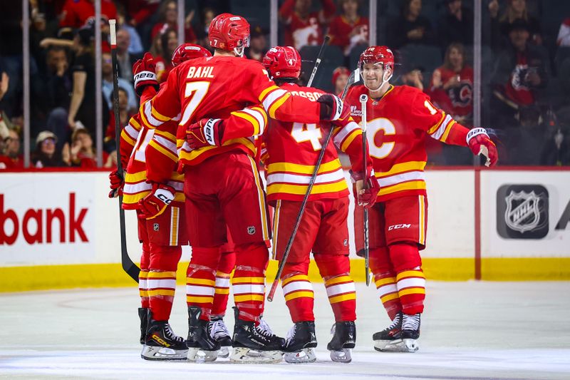Oct 26, 2025; Calgary, Alberta, CAN; Calgary Flames defenseman Kevin Bahl (7) celebrates his goal with teammates against the New York Rangers during the first period at Scotiabank Saddledome. Mandatory Credit: Sergei Belski-Imagn Images