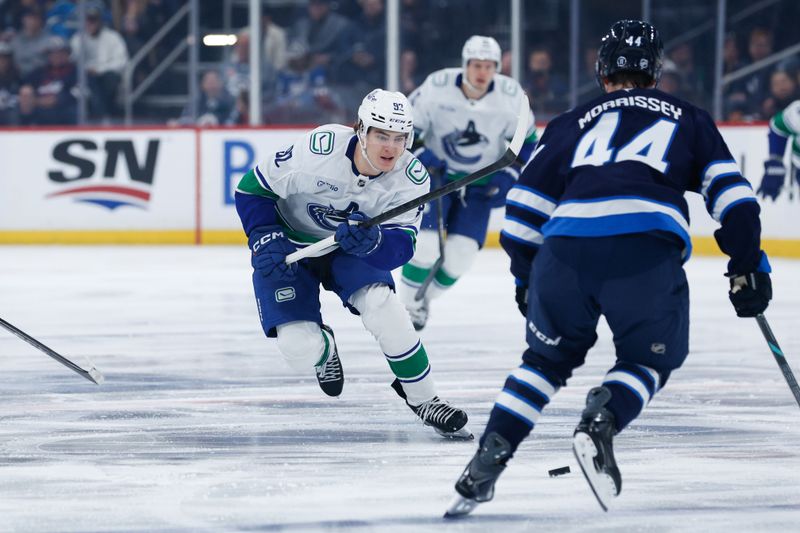 Mar 7, 2026; Winnipeg, Manitoba, CAN;  Vancouver Canucks forward Liam Ohgren (92) skates in on Winnipeg Jets defenseman Josh Morrissey (44) during the first period at Canada Life Centre. Mandatory Credit: Terrence Lee-Imagn Images