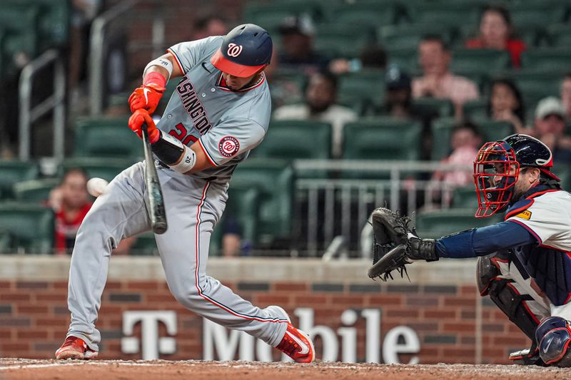 May 29, 2024; Cumberland, Georgia, USA; Washington Nationals catcher Keibert Ruiz (20) singles to drive in two runs against the Atlanta Braves during the ninth inning at Truist Park. Mandatory Credit: Dale Zanine-USA TODAY Sports