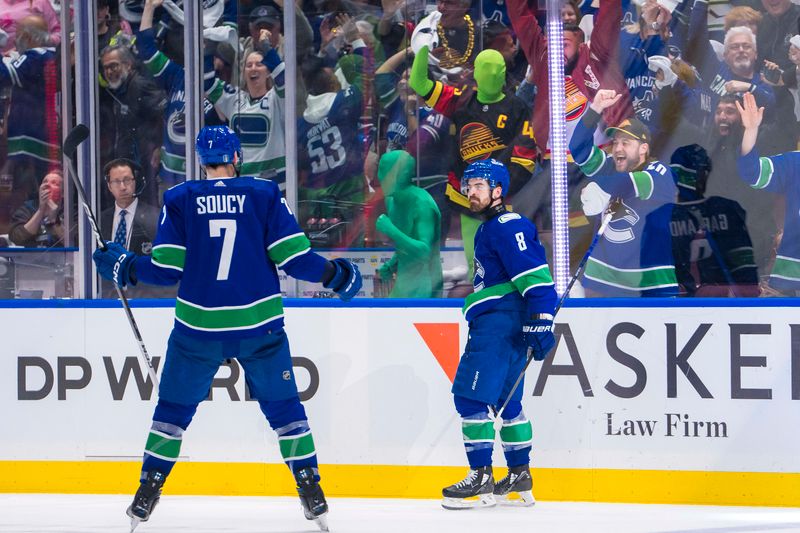 May 8, 2024; Vancouver, British Columbia, CAN; Vancouver Canucks defenseman Carson Soucy (7) and forward Conor Garland (8) celebrate Garland’s game winning goal against the Edmonton Oilers during the third period in game one of the second round of the 2024 Stanley Cup Playoffs at Rogers Arena. Mandatory Credit: Bob Frid-USA TODAY Sports