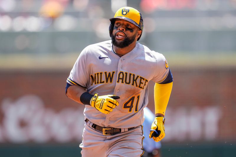 Jul 30, 2023; Cumberland, Georgia, USA; Milwaukee Brewers first baseman Carlos Santana (41) reacts after hitting a home run against the Atlanta Braves during the third inning at Truist Park. Mandatory Credit: Dale Zanine-USA TODAY Sports