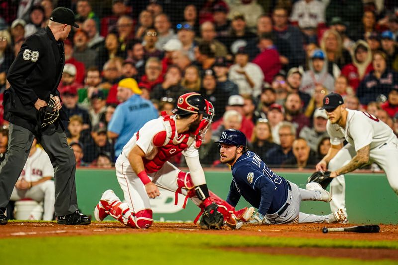 Sep 26, 2023; Boston, Massachusetts, USA; Tampa Bay Rays right fielder Josh Lowe (15) safe at home plat against Boston Red Sox catcher Reese McGuire (3) in the third inning at Fenway Park. Mandatory Credit: David Butler II-USA TODAY Sports