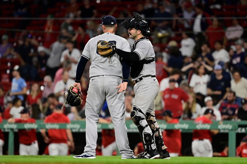 Sep 12, 2023; Boston, Massachusetts, USA; New York Yankees relief pitcher Nick Ramirez (63) and catcher Austin Wells (88) celebrate a win against the Boston Red Sox at Fenway Park. Mandatory Credit: Eric Canha-USA TODAY Sports