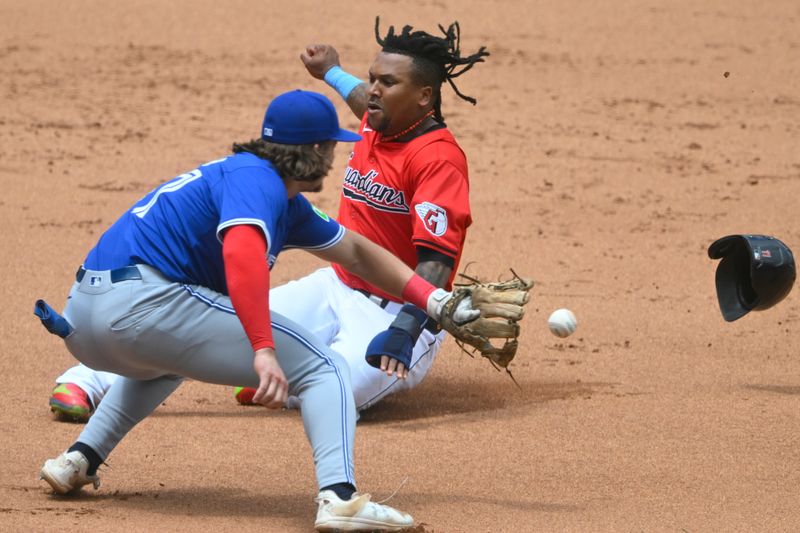 Jun 23, 2024; Cleveland, Ohio, USA; Cleveland Guardians designated hitter Jose Ramirez (11) slides safely to third base beside Toronto Blue Jays third baseman Addison Barger (47) in the first inning at Progressive Field. Mandatory Credit: David Richard-USA TODAY Sports