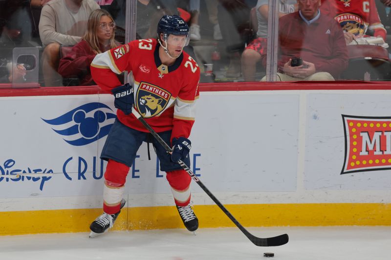 Mar 1, 2025; Sunrise, Florida, USA; Florida Panthers center Carter Verhaeghe (23) moves the puck against the Calgary Flames during the second period at Amerant Bank Arena. Mandatory Credit: Sam Navarro-Imagn Images