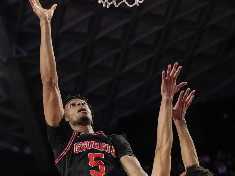 Feb 28, 2023; Athens, Georgia, USA; Georgia Bulldogs center Frank Anselem (5) shoots over Florida Gators guard Myreon Jones (0) during the second half at Stegeman Coliseum. Mandatory Credit: Dale Zanine-USA TODAY Sports