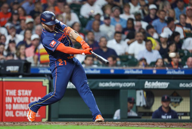 Aug 19, 2024; Houston, Texas, USA; Houston Astros first baseman Yainer Diaz (21) hits a single during the fourth inning against the Boston Red Sox at Minute Maid Park. Mandatory Credit: Troy Taormina-USA TODAY Sports