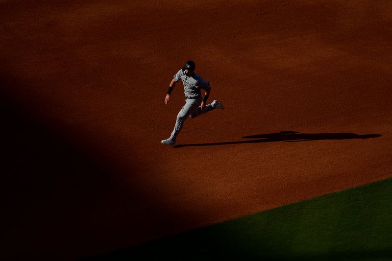 Jun 4, 2023; Los Angeles, California, USA; New York Yankees right fielder Jake Bauers (61) advances to third on a throwing error by Los Angeles Dodgers relief pitcher Brusdar Graterol (48) during the seventh inning at Dodger Stadium. Mandatory Credit: Gary A. Vasquez-USA TODAY Sports