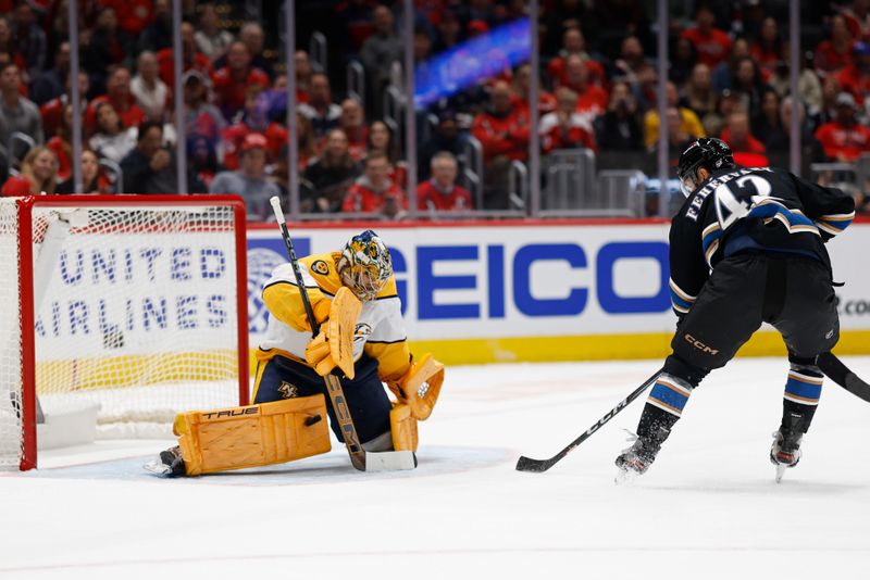 Nov 6, 2024; Washington, District of Columbia, USA; Nashville Predators goaltender Juuse Saros (74) makes a save on Washington Capitals defenseman Martin Fehervary (42) in the first period at Capital One Arena. Mandatory Credit: Geoff Burke-Imagn Images